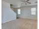 A spacious living room featuring neutral carpet, white walls, and a ceiling fan for comfortable living at 6134 Pine Villa Ave # 103, Las Vegas, NV 89108