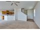 An open concept living room and kitchen area with carpeted floors, white walls, and a ceiling fan at 6134 Pine Villa Ave # 103, Las Vegas, NV 89108