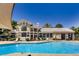 Beautiful community pool with ample seating and well-maintained landscaping under a clear blue sky at 6134 Pine Villa Ave # 103, Las Vegas, NV 89108