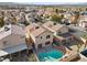 Aerial view of home with backyard pool and spa in neighborhood at 6328 Brianna Peak Ct, Las Vegas, NV 89142