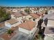 Aerial view showcasing a home with a spacious driveway in a suburban neighborhood with desert landscaping at 6328 Brianna Peak Ct, Las Vegas, NV 89142