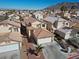 Aerial view features a suburban home with a two-car garage, desert landscaping, and a tile roof at 6328 Brianna Peak Ct, Las Vegas, NV 89142