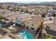 Aerial view showcases a home with a backyard pool and spa in a residential community at 6328 Brianna Peak Ct, Las Vegas, NV 89142