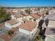 Overhead shot of suburban home with well-maintained lawn, large driveway, and tile roof at 6328 Brianna Peak Ct, Las Vegas, NV 89142