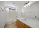 Bright bathroom featuring a shower-tub combo, wood vanity, and large mirror at 6328 Brianna Peak Ct, Las Vegas, NV 89142