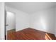 Empty bedroom featuring dark wood floors, carpet in the doorway and white walls at 6328 Brianna Peak Ct, Las Vegas, NV 89142