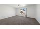Bedroom with plush carpet, a ceiling fan, and a window looking out to the backyard at 6328 Brianna Peak Ct, Las Vegas, NV 89142
