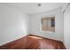 Empty bedroom featuring dark wood floors and a window with horizontal blinds at 6328 Brianna Peak Ct, Las Vegas, NV 89142