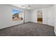 Spacious bedroom with plush carpet, lots of light, and an attached bathroom at 6328 Brianna Peak Ct, Las Vegas, NV 89142