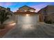 Two-story home boasts a two-car garage and a well-maintained driveway at 6328 Brianna Peak Ct, Las Vegas, NV 89142