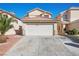 Two-story home boasts a two-car garage and a well-maintained driveway at 6328 Brianna Peak Ct, Las Vegas, NV 89142