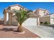 Two-story home boasts a two-car garage and a well-maintained driveway, surrounded by desert landscaping at 6328 Brianna Peak Ct, Las Vegas, NV 89142