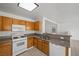 Cozy kitchen with oak cabinets, granite counters, and white appliances at 6328 Brianna Peak Ct, Las Vegas, NV 89142