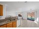 Bright kitchen features granite counters, wooden cabinets, and a lovely view to the backyard pool at 6328 Brianna Peak Ct, Las Vegas, NV 89142