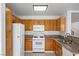 Bright kitchen features oak cabinets, granite counters and white appliances at 6328 Brianna Peak Ct, Las Vegas, NV 89142