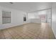 Bright and airy living room with tile flooring, and natural light from several windows at 6328 Brianna Peak Ct, Las Vegas, NV 89142