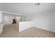 Bright, open-concept living room with neutral tile flooring and staircase to the second floor at 6328 Brianna Peak Ct, Las Vegas, NV 89142