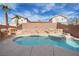 Backyard pool and spa with rock feature under a partly cloudy sky at 6328 Brianna Peak Ct, Las Vegas, NV 89142