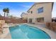 Backyard pool with rock waterfall feature, spacious patio, and desert landscaping provide a backyard oasis at 6328 Brianna Peak Ct, Las Vegas, NV 89142