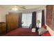 Bedroom featuring a large window, wardrobe, exercise bike, and red bedding accents at 6445 Glory Rise Ct, Las Vegas, NV 89142