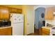 Kitchen with white refrigerator, microwave, and wooden cabinets offers a cozy atmosphere at 6445 Glory Rise Ct, Las Vegas, NV 89142