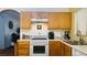 Kitchen with wood cabinets and white appliances at 6445 Glory Rise Ct, Las Vegas, NV 89142