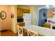 Eat-in kitchen includes wooden cabinets, white appliances, and island with white countertop at 6445 Glory Rise Ct, Las Vegas, NV 89142