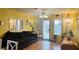 Bright living room with natural light, neutral decor, and a sliding glass door to the backyard at 6445 Glory Rise Ct, Las Vegas, NV 89142