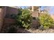 Backyard landscape with retaining walls, gravel, and green bushes at 6541 Chinatown St, Las Vegas, NV 89166