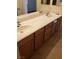 Bathroom featuring double sinks with a long countertop and vanity cabinets at 6541 Chinatown St, Las Vegas, NV 89166
