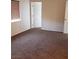 Bedroom with carpet flooring, a window, and a white paneled door at 6541 Chinatown St, Las Vegas, NV 89166