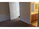 Bedroom with carpet flooring, a white door, and an entrance to the bathroom at 6541 Chinatown St, Las Vegas, NV 89166