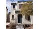 Inviting two-story home featuring an arched entryway and desert landscaping at 6541 Chinatown St, Las Vegas, NV 89166