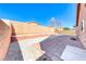 Fenced backyard featuring a patio area and low-maintenance gravel landscaping at 6552 Coldwater Bay Dr, Las Vegas, NV 89122