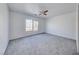 Spacious bedroom with neutral carpet, a ceiling fan, and a large window at 6552 Coldwater Bay Dr, Las Vegas, NV 89122