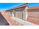 Side view of single story home with white door and desert landscaping at 6552 Coldwater Bay Dr, Las Vegas, NV 89122