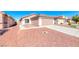 Single-story home featuring a two-car garage and easy-care desert landscaping at 6552 Coldwater Bay Dr, Las Vegas, NV 89122