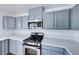 Kitchen featuring stainless steel appliances, light countertops, and light blue cabinetry at 6552 Coldwater Bay Dr, Las Vegas, NV 89122