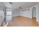 Open living room with wood floors, ceiling fan and view of the backyard patio at 6552 Coldwater Bay Dr, Las Vegas, NV 89122