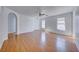 Clean living room with wood floors, white walls, ceiling fan and arched doorways at 6552 Coldwater Bay Dr, Las Vegas, NV 89122