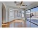 Cozy living room featuring wood floors, a ceiling fan, and a glass sliding door at 6552 Coldwater Bay Dr, Las Vegas, NV 89122