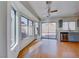 Bright living room with wood floors, ceiling fan, and sliding doors to the backyard at 6552 Coldwater Bay Dr, Las Vegas, NV 89122