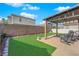 Backyard featuring an outdoor lounge area, manicured lawn, and block wall for added privacy at 6817 Frances Celia Ave, Las Vegas, NV 89122