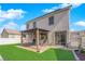 Backyard featuring an outdoor lounge area, manicured lawn, and a sliding door for easy access to the home at 6817 Frances Celia Ave, Las Vegas, NV 89122