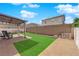 Backyard featuring an outdoor lounge area, manicured lawn, and a tall block wall for privacy at 6817 Frances Celia Ave, Las Vegas, NV 89122