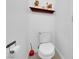 Cozy half-bathroom with wood shelf, decorated with floral arrangements and soap dispenser above the toilet at 6817 Frances Celia Ave, Las Vegas, NV 89122