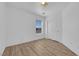 Bright bedroom featuring neutral walls, laminate wood flooring, closet, and natural light from a large window at 6817 Frances Celia Ave, Las Vegas, NV 89122