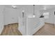 Hallway featuring wood floors, white trim, and decorative lighting with an abundance of natural light at 6817 Frances Celia Ave, Las Vegas, NV 89122