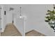 Hallway featuring wood floors, white trim, decorative lighting and neutral colored walls at 6817 Frances Celia Ave, Las Vegas, NV 89122