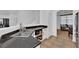 Modern kitchen with stainless steel sink and black countertops with white cabinets at 6817 Frances Celia Ave, Las Vegas, NV 89122